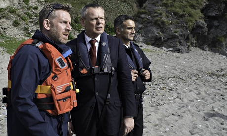 Martin Clunes as Doc Martin with Cornishmen Gerry (Paul Thornley) and PC Joe (John Marquez). Photogr