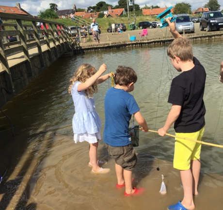Snapshot ... Sarah Neary’s children, Calum and Holly, crabbing with their friend Dillon in Suffolk. 