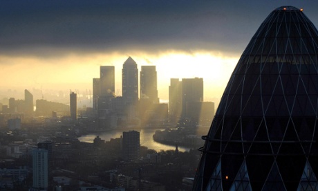 Embargoed to 0001 Monday January 7File photo dated 25/02/10 of the 'Gherkin' and Canary Wharf at sunrise in the City of London as the average bonus for a FTSE 100 chief executive rose by 3% to  1.12 million this year, according to a new report by PwC, that raises questions about how closely boards responsible for setting the awards are judging bosses' performances. PRESS ASSOCIATION Photo. Issue date: Monday January 7, 2013. See PA story CITY Pay. Photo credit should read: Stefan Rousseau/PA Wire