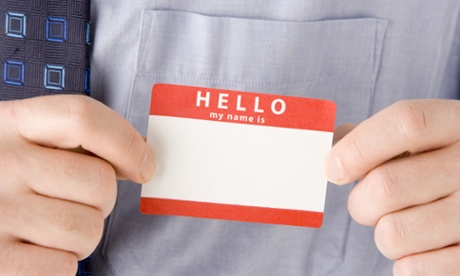 Hands holding name badge
