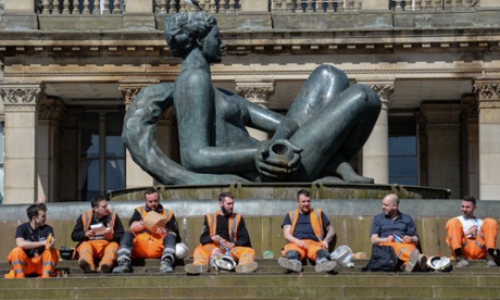 Builders sit in the drained fountain nicknamed the Floozie in the Jacuzzi in Birmingham's Victoria Square during a heatwave.