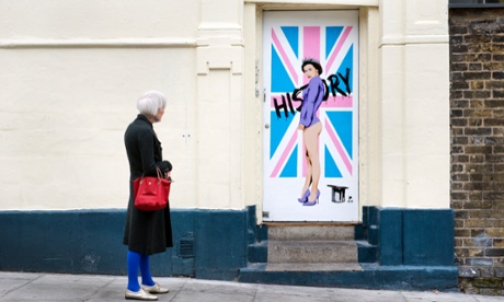 A picture of the street artist Pegasus's portrait of the Queen,  side-on wearing just a purple jacket, her crown and high heels, her legs and buttocks bare