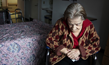 Elderly woman sits in her room at a nursing home