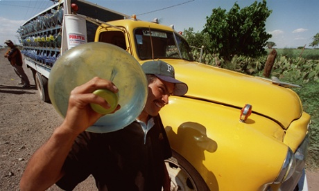 Water salesman carries a five-gallon jug of potable water in the village of Ejido Hermosillo, in Baja California, Mexico.