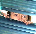 Parents spying on their children through a venetian blind