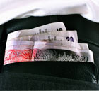 A man with a wad of money in his back pocket