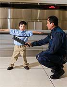 Officer searching a toddler at the airport