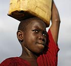 A child carrying water from a borehole in Katine