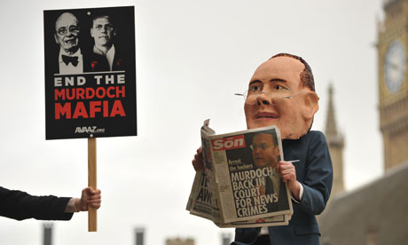 Protester in James Murdoch mask