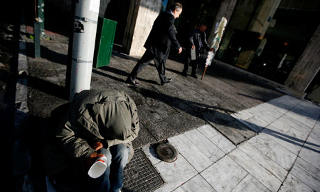 A homeless man begs for money in Athens