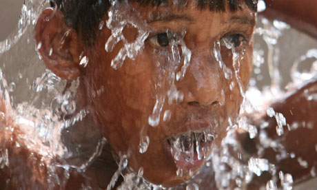 Bangladeshi boy splashes water