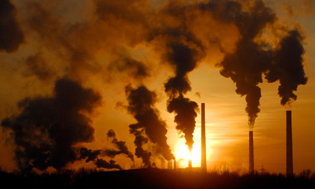 Smoke rises from chimneys of a factory during sunset in the Siberian town of Achinsk