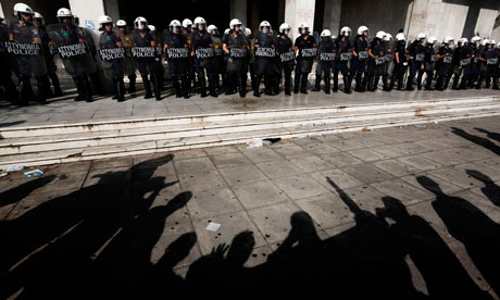 Greek protesters face police following a demonstration in Athens