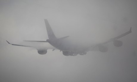 A plane takes off at Heathrow in the fog
