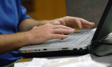 Man's hands typing on laptop