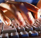 Man typing on a computer keyboard