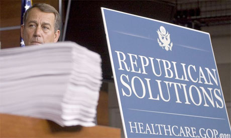 Then House minority leader John Boehner standing behind a copy of the 
