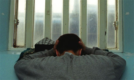 Young inmate looking depressed in prison cell, Portland 