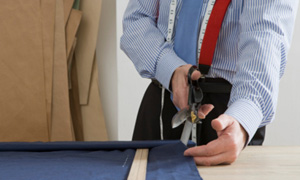 Tailor cutting cloth