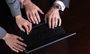 Hands trying to share a computer
