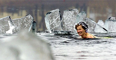 Winter swimming in ice covered lake