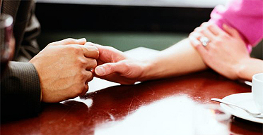 Couple on a date holding hands in a restaurant