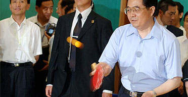 China's president Hu Jintao shows off his table tennis skills