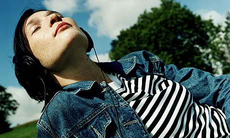 Woman listening to headphones in the park