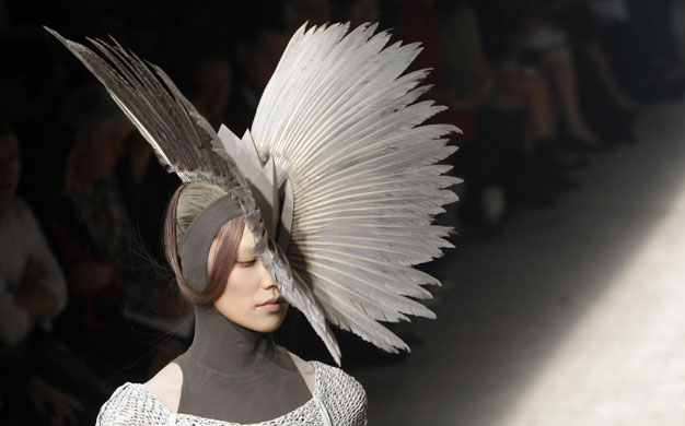 Gareth Pugh: A model wears a feathered headdress by Gareth Pugh
