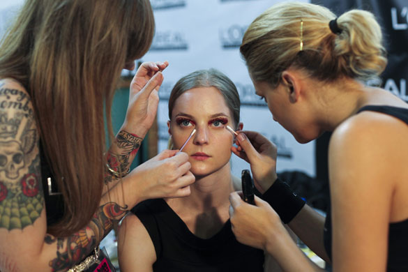 Lisbon fashion week: A model gets her makeup done backstage