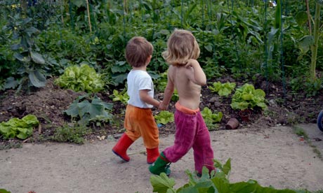 Children hand-in-hand at an allotment
