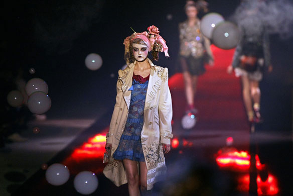 Hair accessories: A model wears and outfit by John Galliano