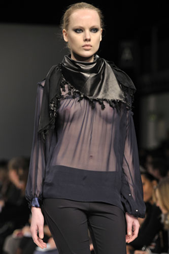 London fashion week: Noir: A model wears an outfit by Noir