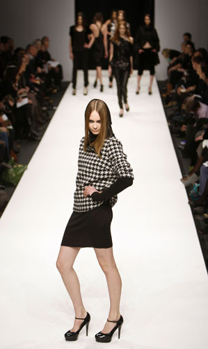 London fashion week: Noir: A model wears an outfit by Noir