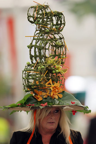 Chelsea weird stuff: A woman wears a hat made out of flowers at Chelsea Flower Show