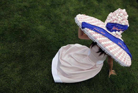 ladies day ascot: Ladies' Day at Ascot and a racegoer wears a hat of marshmallows