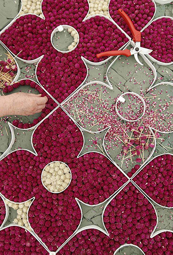 Chelsea flower show: A worker adjusts a floral arrangement