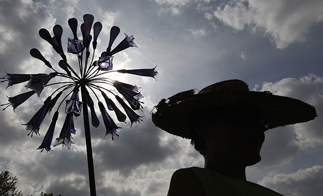 Chelsea flower show: A gardener is silhouetted next to a glass flower