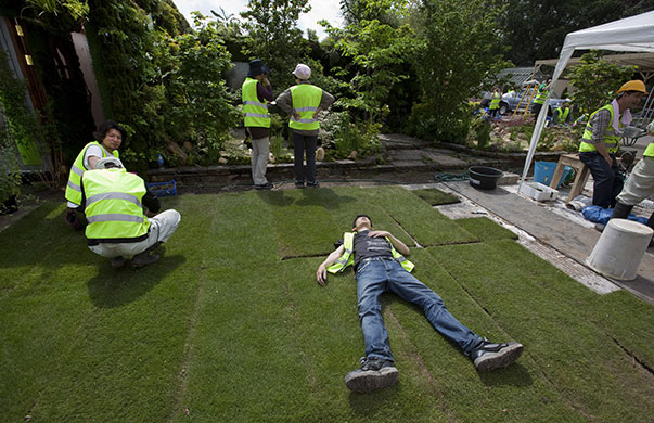 Chelsea flower show: A gardener takes some rest in the sunshine outside the Kazahana garden