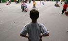A boy standing alone in the playground