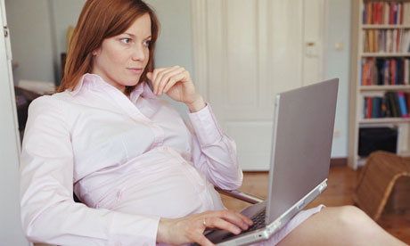 Pregnant woman using a laptop