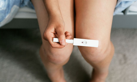 A girl holding pregnancy test