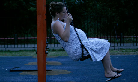 Pregnant woman on a swing