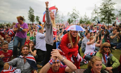 Fans watch the big screen in the Olympic Park