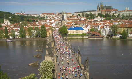 Runners in the Prague marathon cross the Charles bridge