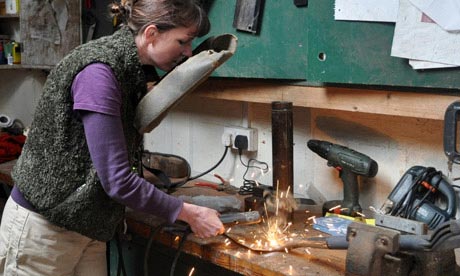Kim Stoddart repairing a garden spade using a welder