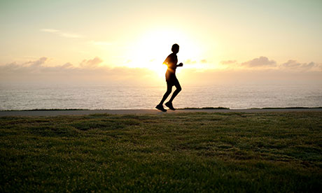 A silhouette of a jogger running alone 