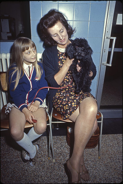 Vintage Blue Cross photos: Woman and girl with dog in the waiting room