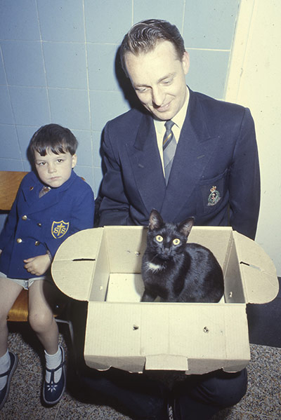 Vintage Blue Cross photos: man and boy with cat in waiting room