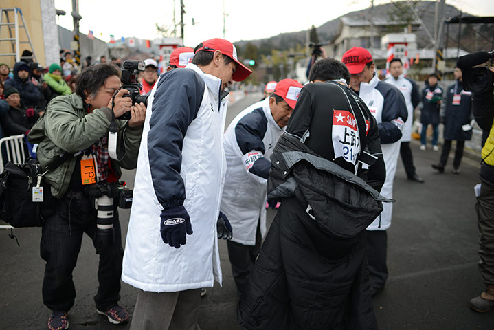 Hakone ekiden: Marshals check a runner